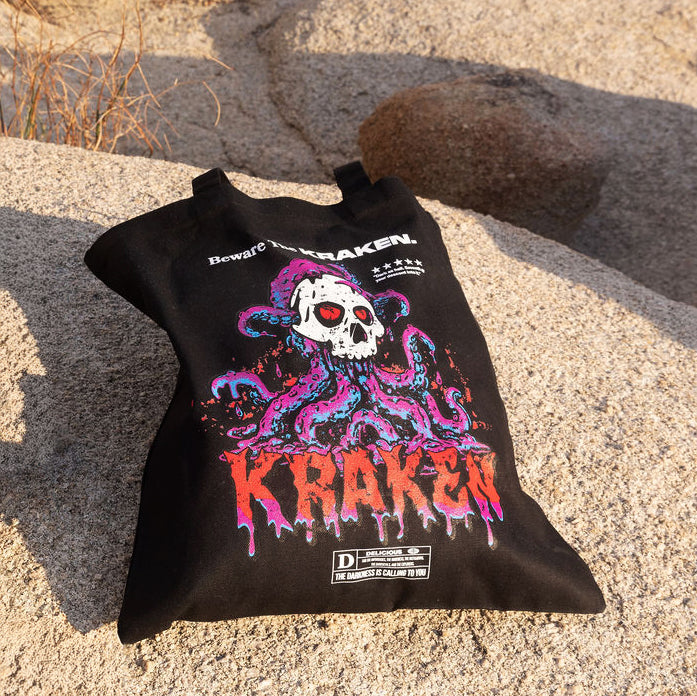 Image of Beware The Kraken Tote bag laid out on a boulder in the desert.