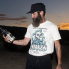 Front view of the Beware The Kraken Tee in ivory on a male model in the desert