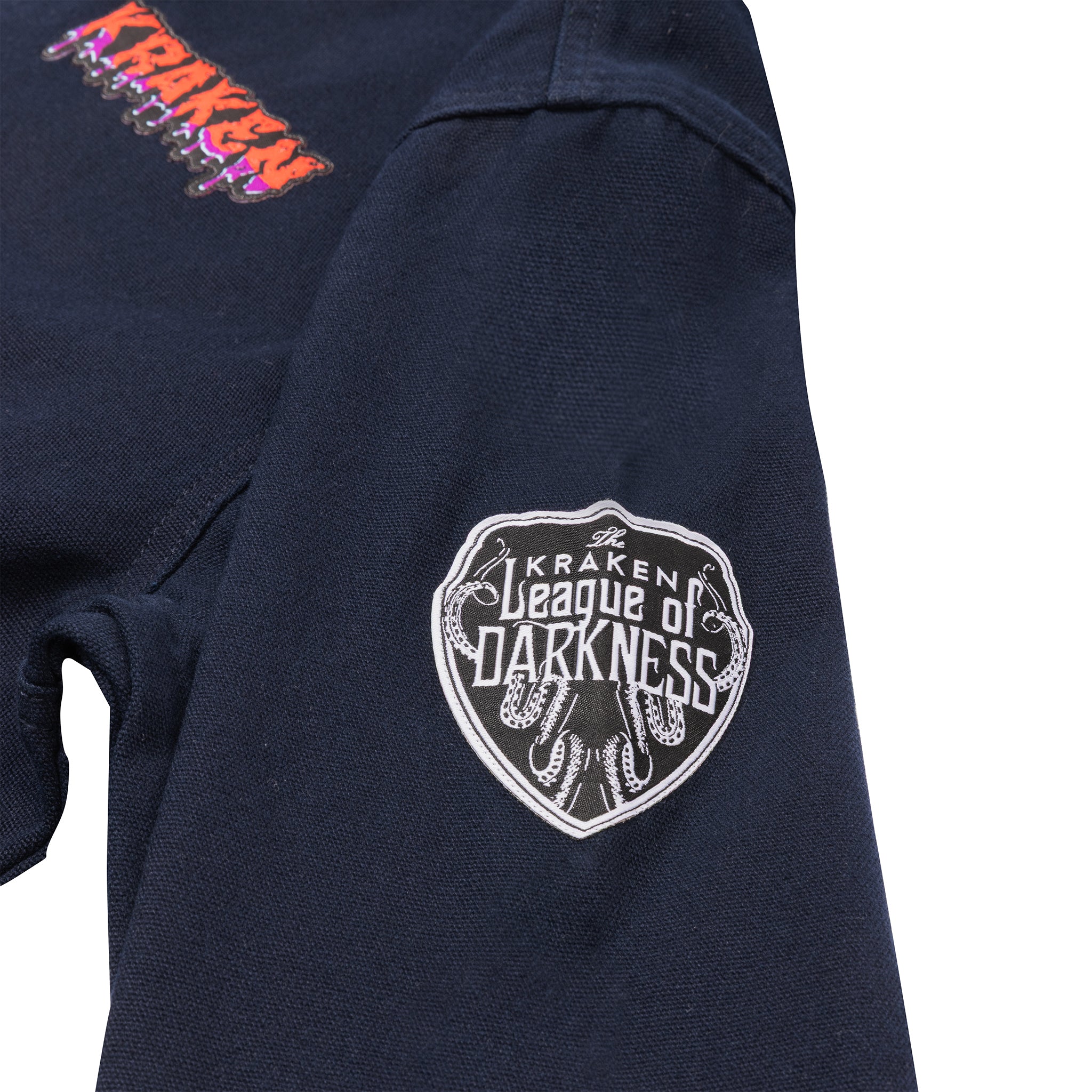 A close up view image of the Beware The Kraken Coveralls with a League of Darkness patch on the left sleeve