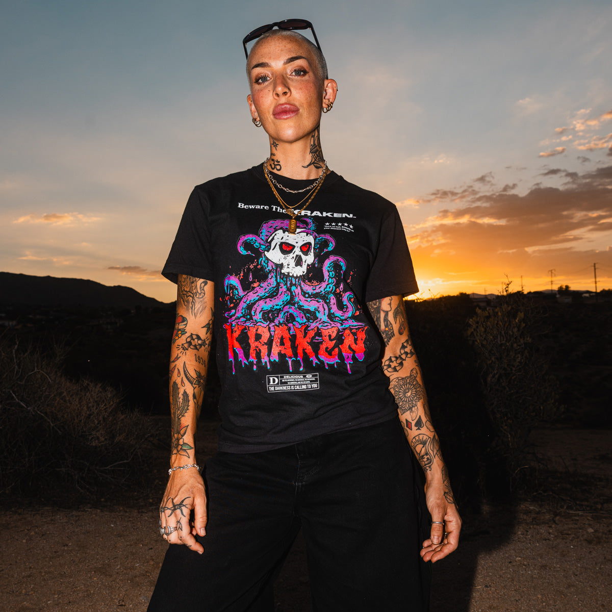 Front view of the Beware The Kraken Tee in black on a female model in the desert