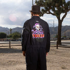 A back view lifestyle image of the Beware The Kraken Coveralls on a male model in the desert