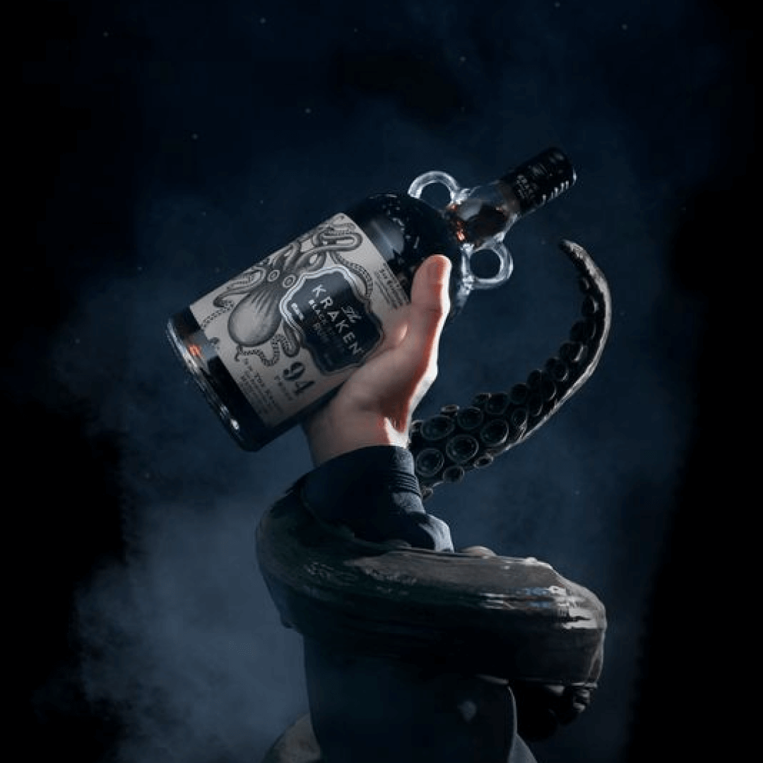 A hand holds a bottle of Kraken Black Spiced Rum, featuring an octopus design, 94 proof.