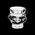 Crystal skull-shaped glass with 'The Kraken Spiced Rum' branding on a black background