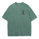 Green t-shirt with a small Kraken Rum bottle graphic printed on the left chest with text around the graphic reads "Bizarre & Fierce"