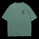 Green t-shirt with a small Kraken Rum bottle graphic printed on the left chest with text around the graphic reads "Bizarre & Fierce"