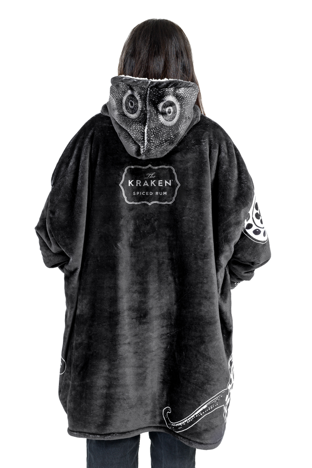 Back view of a woman wearing a Kraken-branded Uggie with a view of the hood and Kraken Rum logo on the back