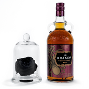 A bottle of Kraken Gold Spiced Rum with a Dome featureing a large size single preserved black rose.