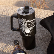 A lifestyle image of The Kraken tumbler on a boulder
