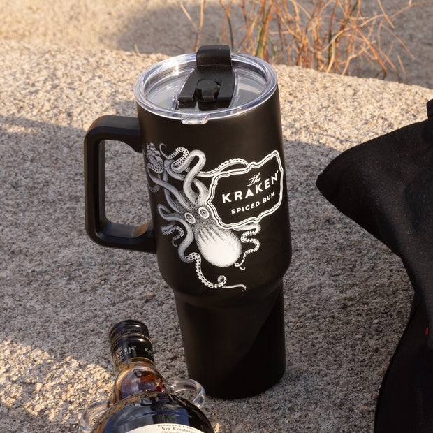 A lifestyle image of The Kraken tumbler on a boulder